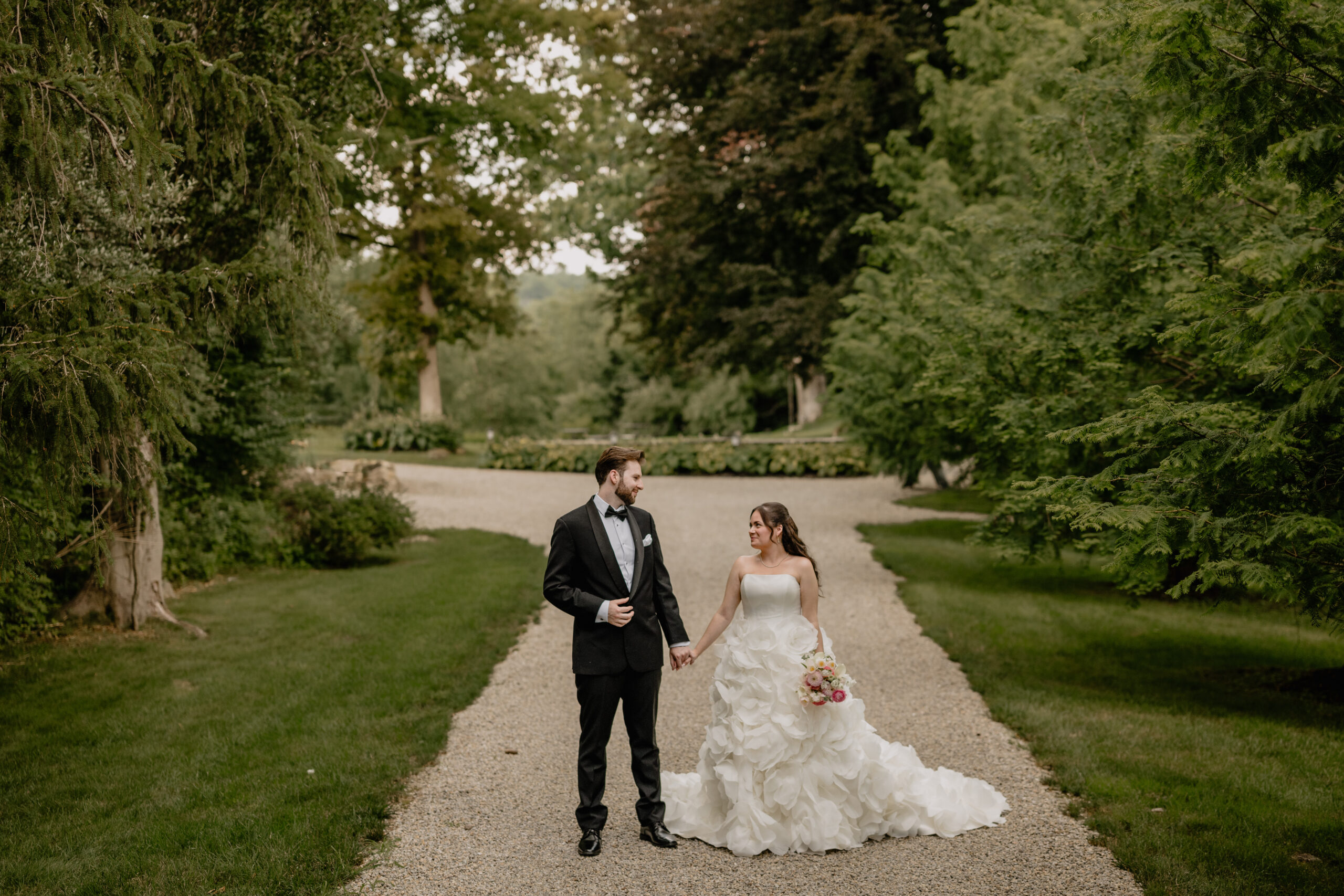 Couple's portrait surrounded by lush greens before their Beautiful Wedding at Crossed Keys Estate.