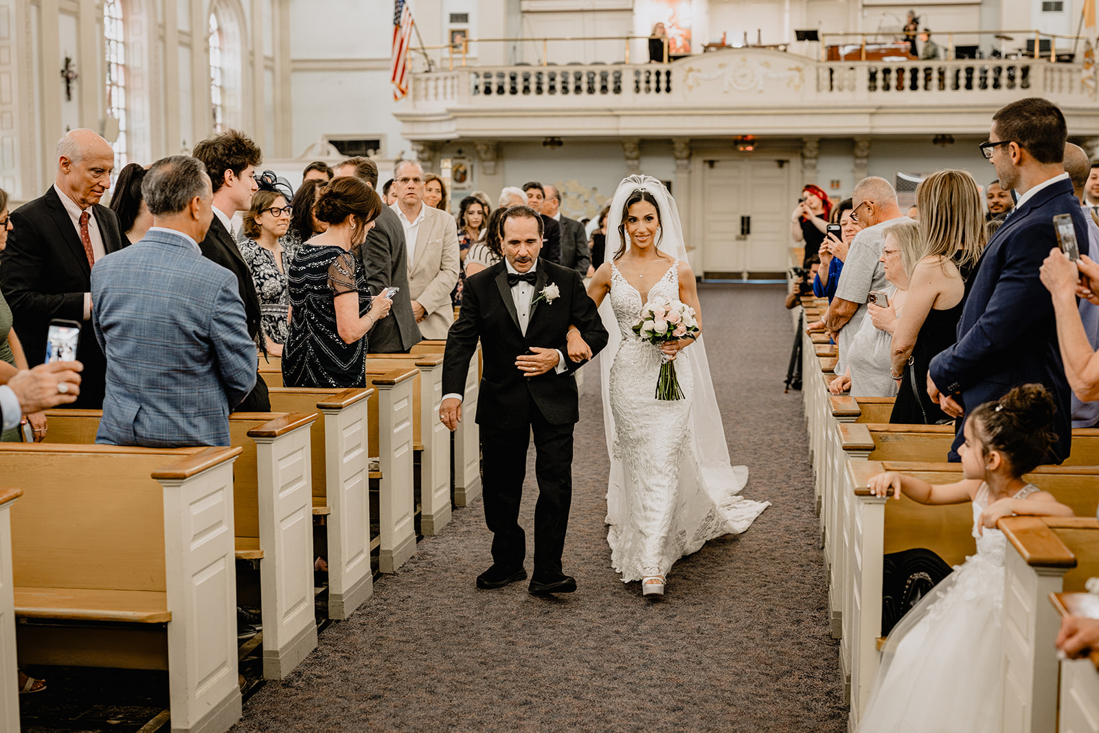 Bride walking down the aisle with her father at their Wedding at Shadowbrook.