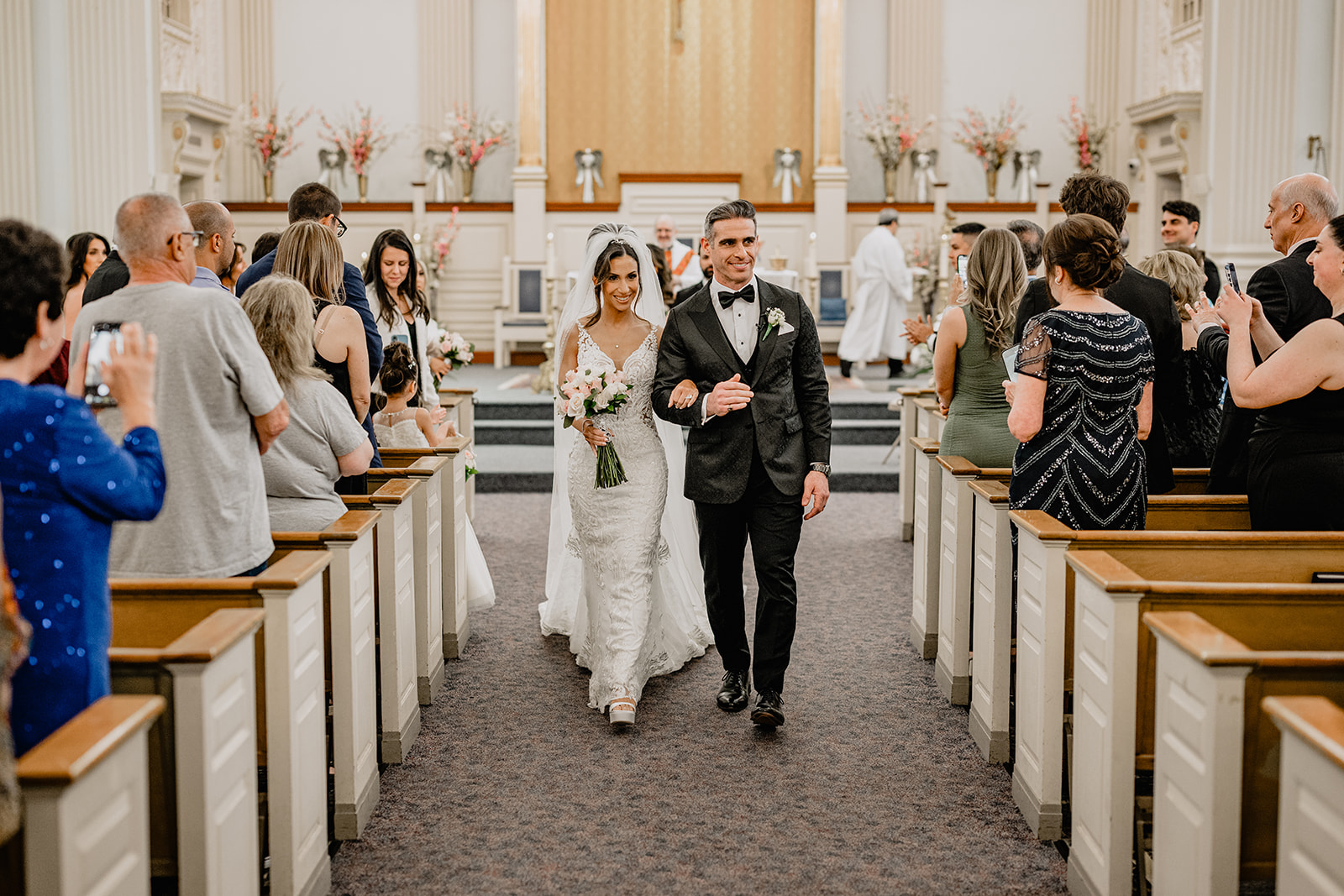 Couple walking down the aisle as newlyweds at their Wedding at Shadowbrook. 