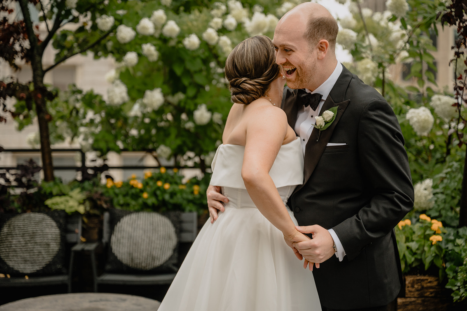 Couple hugging before their intimate wedding at Tribeca Rooftop
