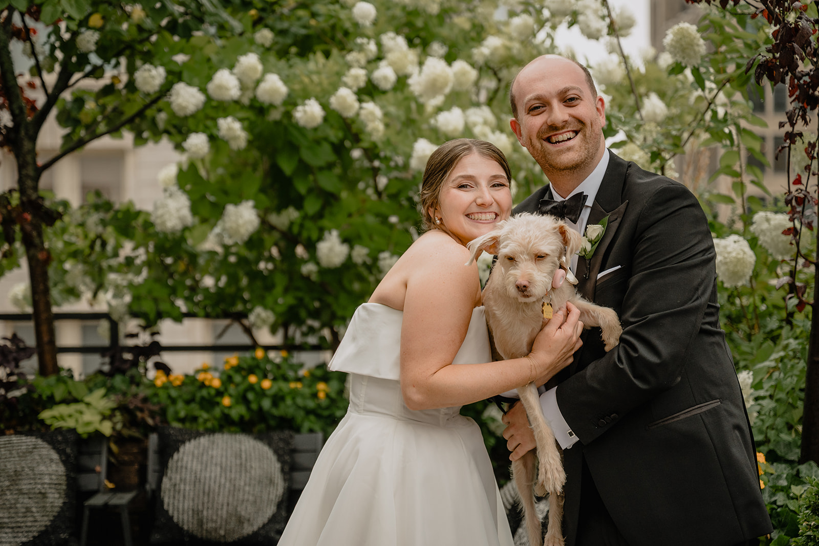 Couple with their fur baby before their intimate wedding at Tribeca Rooftop