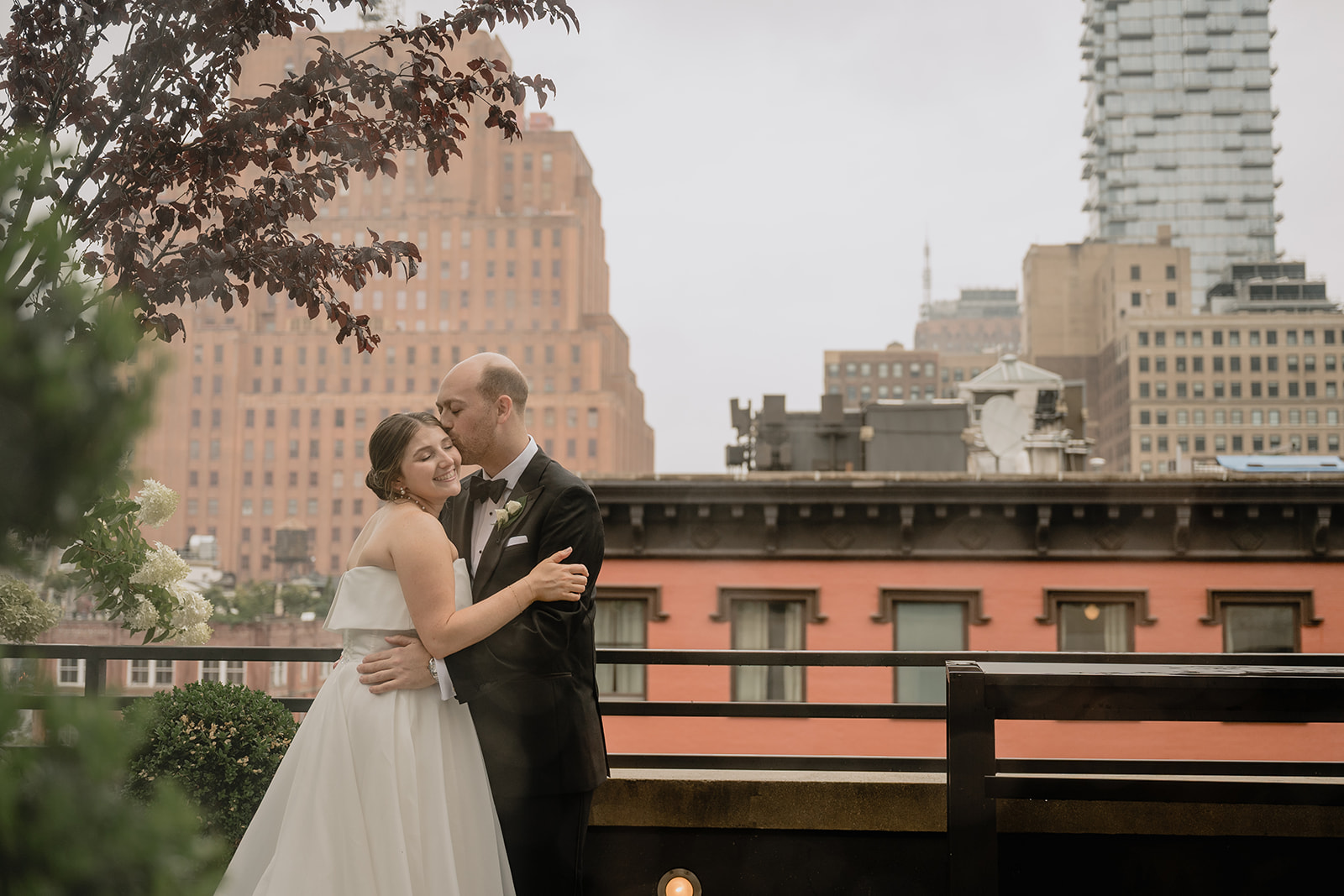 Couple's portrait with city background before their intimate wedding at Tribeca Rooftop