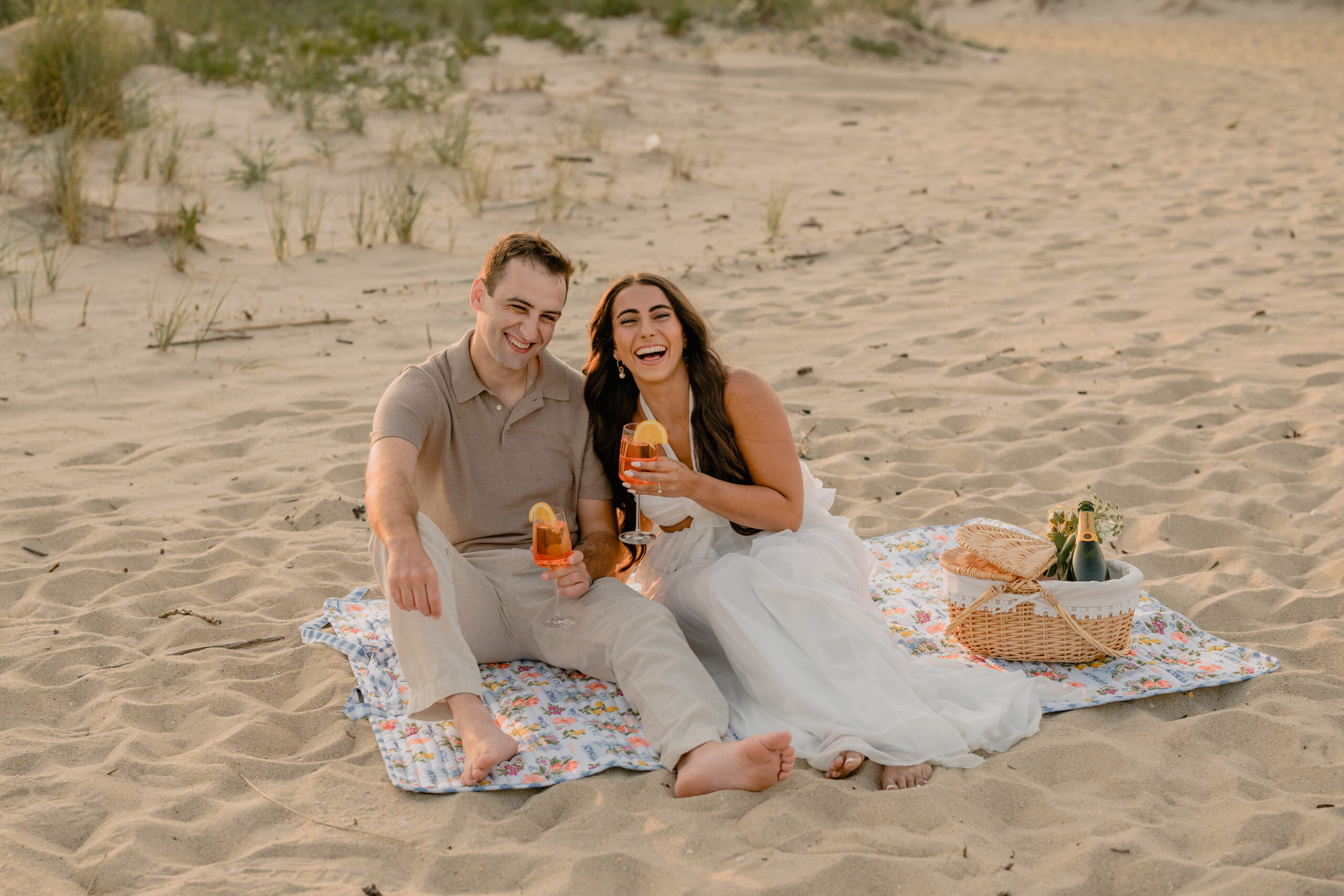 Couple having a picnic by the beach during their Deep Cut Gardens & Sandy Hook Beach Engagement Session