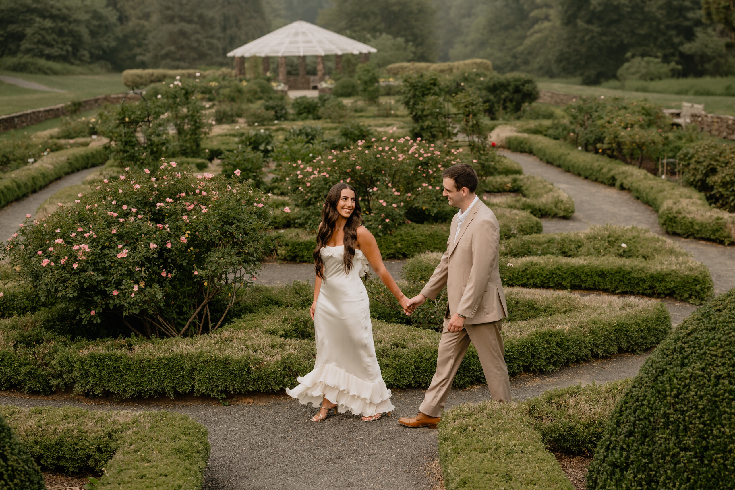 Couple walking on their Deep Cut Gardens & Sandy Hook Beach Engagement Session