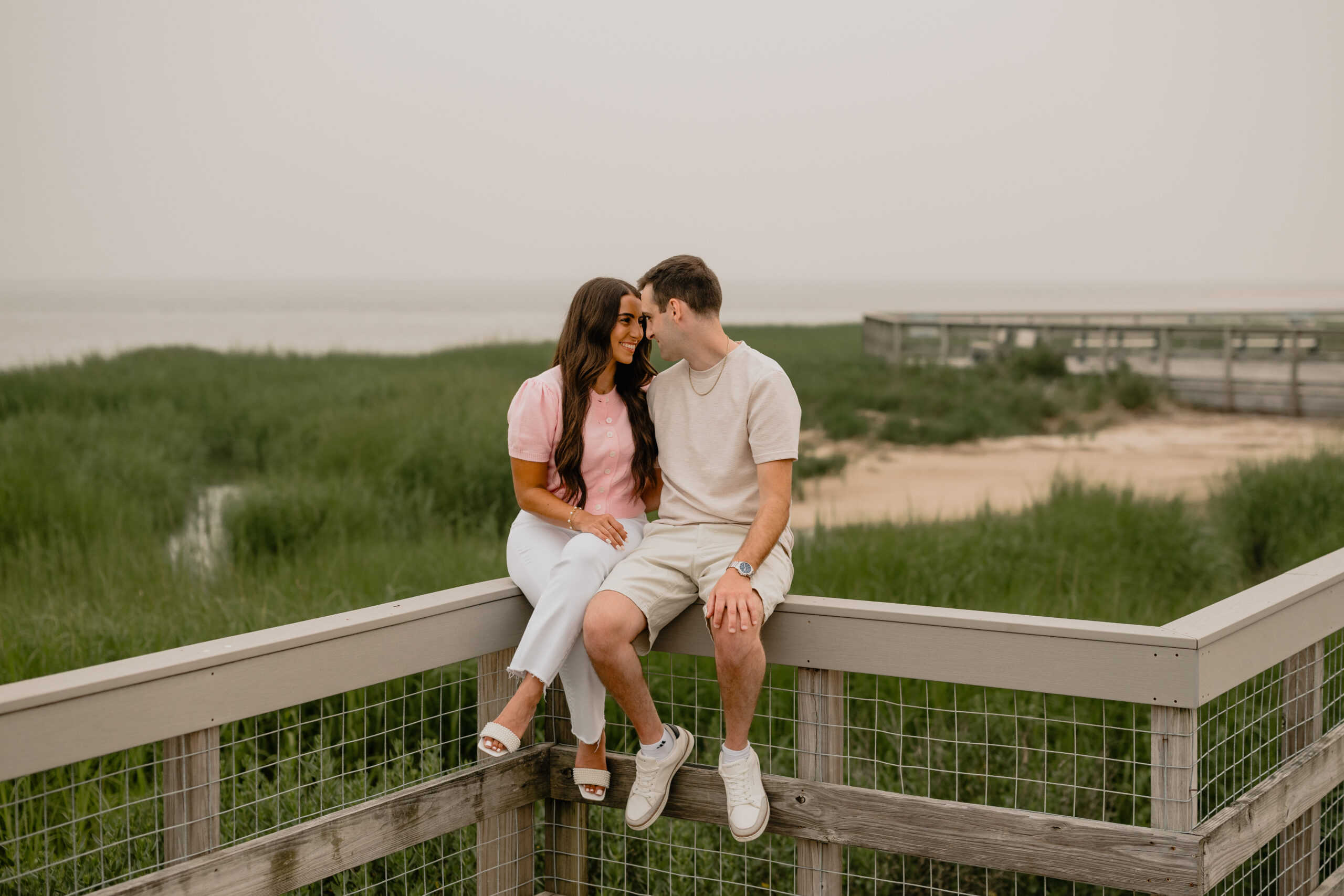 Couple sitting during their Deep Cut Gardens & Sandy Hook Beach Engagement Session