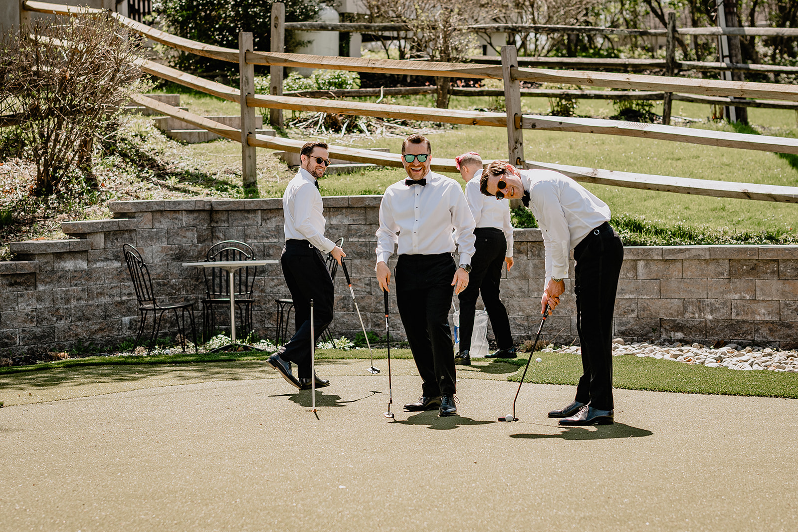 Groom playing golf with the groomsmen before their beautiful wedding at Crossed Keys Estate.